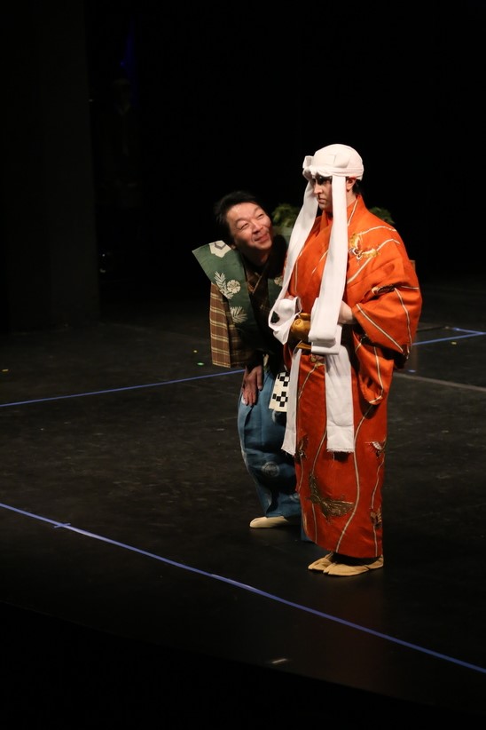 2 performers on a stage performing kyogen