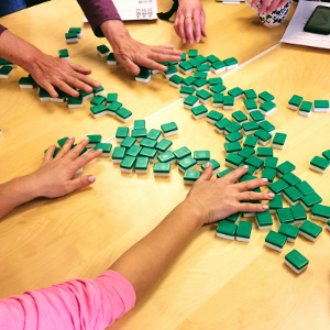 hands shuffling mahjong tiles