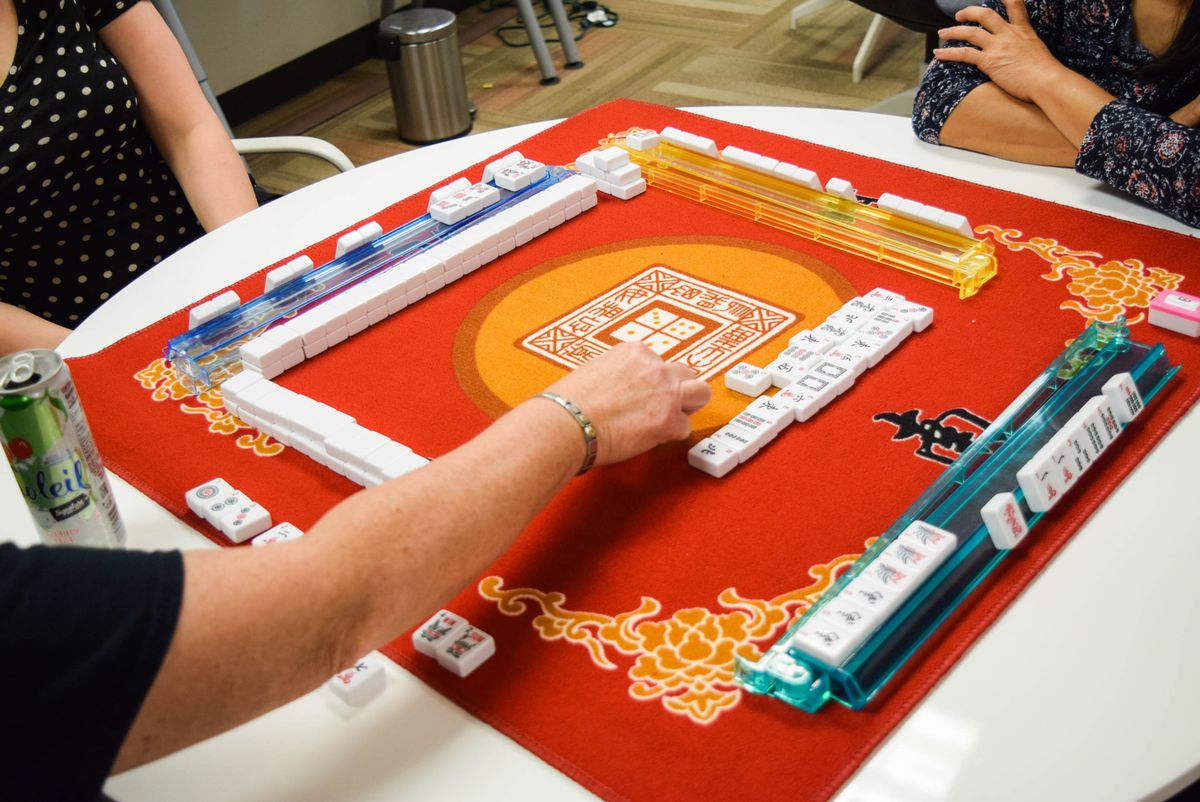 four people playing mahjong